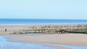 A beach with rocky terrain and calm waters. - 2 bedroom amazing home in Houlle (Houlle)