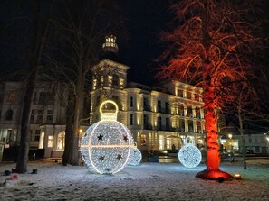 A historic building with illuminated spherical decorations and a prominent tower.
