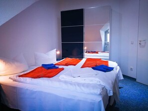 A hotel room with a bed, a large mirror, and a blue carpet. - 4 Room 1 - Wohnpark Binz (with indoor pool) (Binz)
