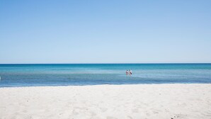 A beach with a clear sky and calm sea. - Nice home in Væggerløse with sauna (Væggerløse)