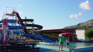 A water park with multiple slides and a swimming pool. - Holiday apartment with shared-use pool (Baška)
