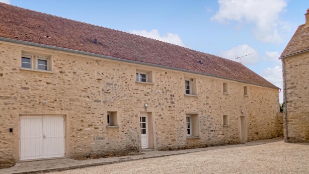 A stone building with a tiled roof, a white door, and small windows. - Lovely home in Vaudoy-en-Brie with WiFi (Vaudoy-en-Brie)