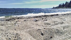 A rocky beach with waves crashing onto the shore.