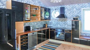A modern kitchen with black cabinetry, a microwave, a sink, and a stove. - 2 bedroom lovely home in Kalmar (Kalmar)