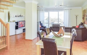 A spacious living area with a dining table, leather sofas, and a television. - Beautiful home in Insel Poel/Kirchdorf (Insel Poel/Kirchdorf)