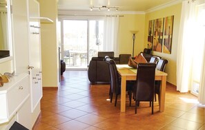 A dining area with a table and chairs, a sofa, and a view of the outside. - Beautiful home in Insel Poel/Kirchdorf (Insel Poel/Kirchdorf)