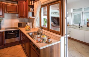 Fridge, stovetop, dishwasher, coffee/tea maker