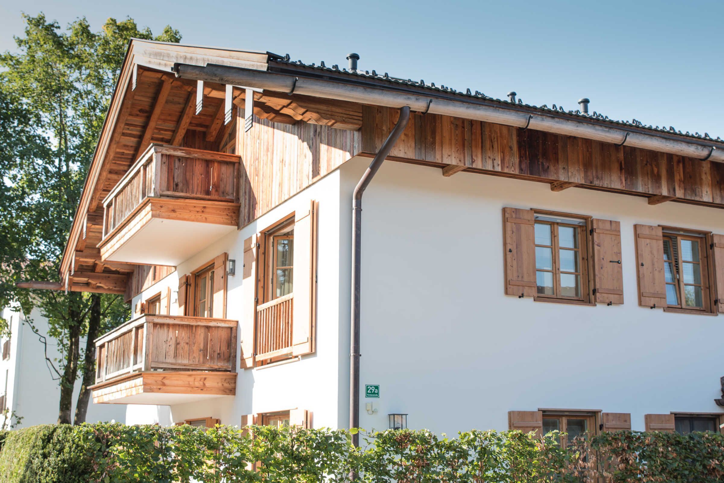 A multi-story building with wooden balconies and shutters.