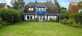 Holiday apartment with balcony, water view and garden