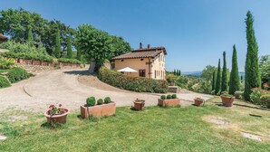 A house with a sloped roof, surrounded by a gravel driveway and a well-maintained lawn. - Awesome apartment in S. Giustino Valdarno with house a panoramic view (S. Giustino Valdarno)