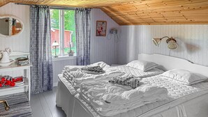 A bedroom with two beds, a dresser, a mirror, and a window with curtains. - 2 bedroom cozy home in Högsäter (Högsäter)