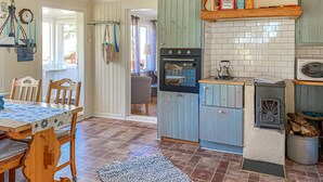 A kitchen with a stove, oven, microwave, and a kettle on the countertop. - 2 bedroom cozy home in Högsäter (Högsäter)