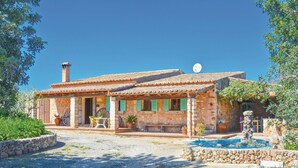 A rustic stone house with a tiled roof, a chimney, and a satellite dish. - Nice home in Pòrtol with kitchen (Pòrtol)