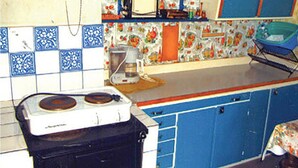 A kitchen with a stove, a coffee maker, and a microwave on the countertop. - Amazing home in Hagfors (Hagfors)