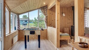 A cozy wooden room with a foosball table, a sofa, and a fireplace. - 3 bedroom lovely home in Sæby (Sæby)