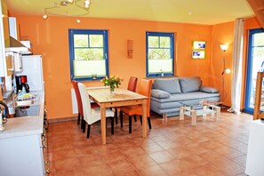 A compact living space with a kitchen, dining area, and seating area.