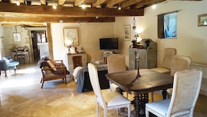 A dining area with a wooden table and six chairs, a television, and a cabinet. - Stunning home in RUFFEY LES BEAUNE (RUFFEY LES BEAUNE)