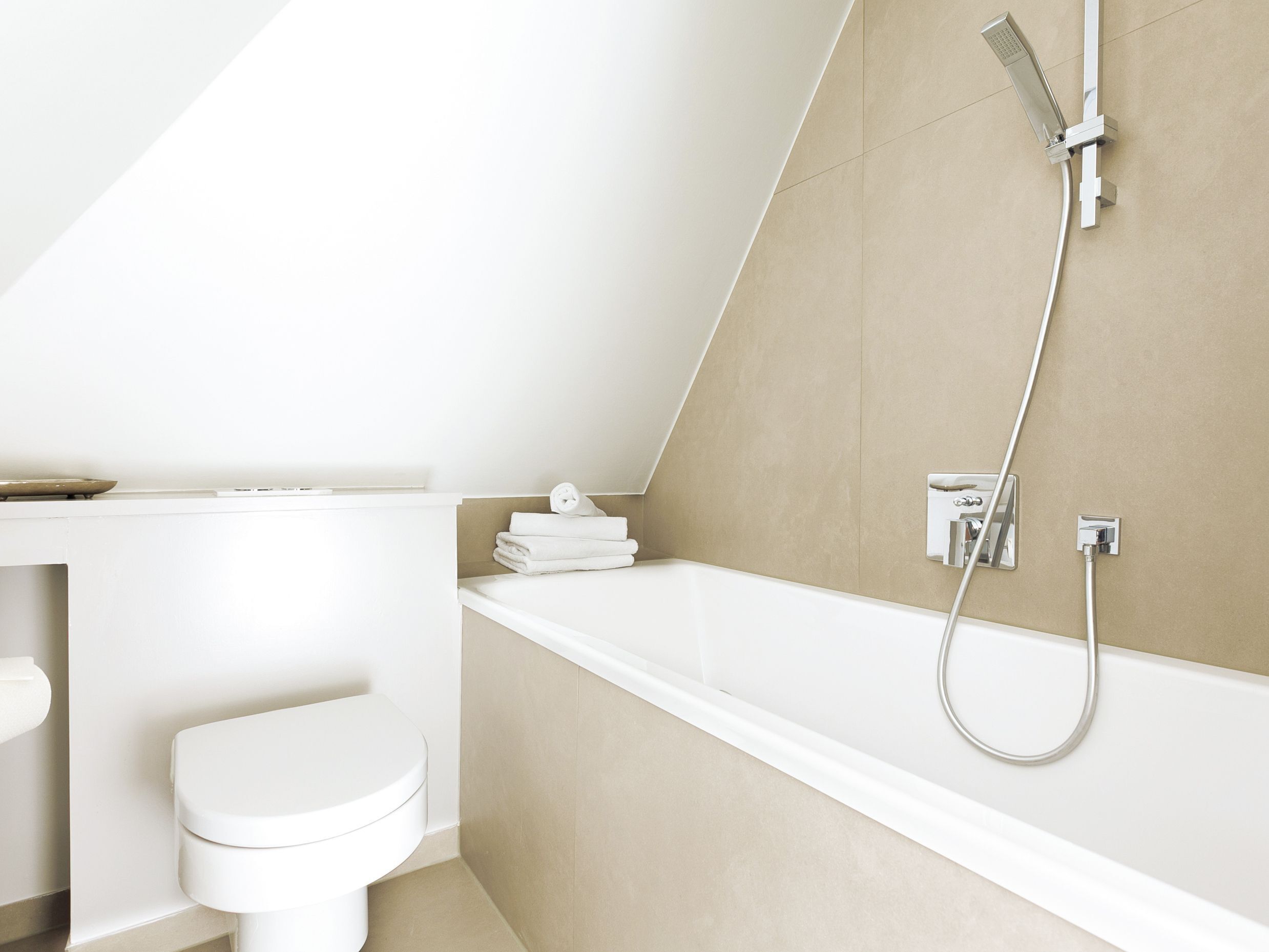 A modern bathroom with a toilet, a sink, and a bathtub.