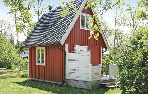 A small red wooden house with a sloped roof and a white front door. - 1 bedroom amazing home in Visby (Visby)