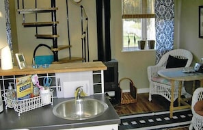 A compact kitchen with a sink, a wooden counter, and a chair. - 1 bedroom amazing home in Visby (Visby)