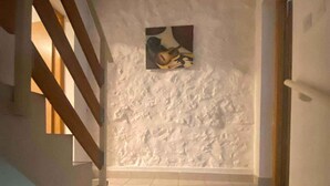 A staircase with a textured wall and a framed picture. - Holiday home with internet access and sea view (Novi Vinodolski)