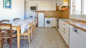 Cocina compacta con lavadora, microondas y lavaplatos.