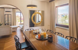 Enjoy a leisurely breakfast at the dining table, set with a tray of refreshments and comfortable seating for six.
