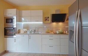 Enjoy cooking in this well-equipped kitchen with an oven, microwave, and refrigerator.