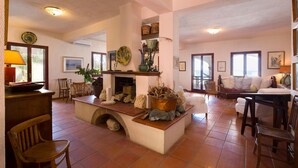 A spacious living area with a fireplace, wooden furniture, and a view of the sea through large windows. - 3 bedroom beautiful home in Scilla (RC) (Scilla (RC))