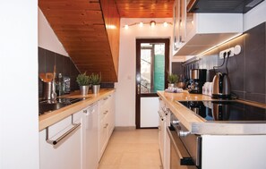 Fridge, stovetop, dishwasher, coffee/tea maker