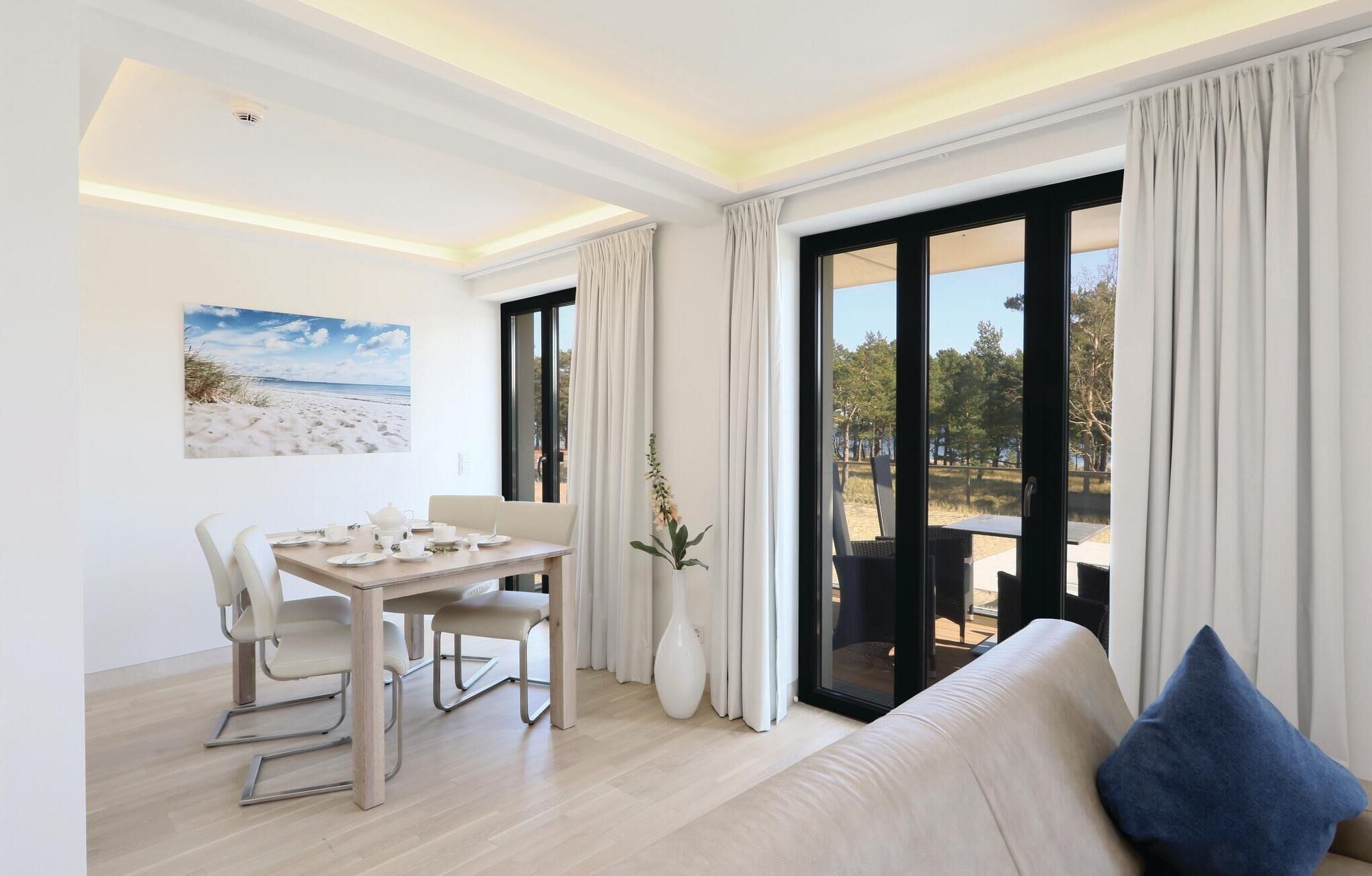 A modern living room with a sofa and a dining table set for two.