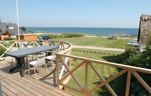 Relax on the deck with a table and chairs, taking in the unobstructed sea view.