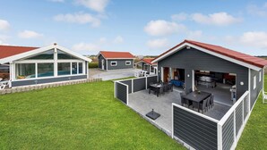 A modern residential complex with multiple houses, each featuring a swimming pool, outdoor seating, and a well-maintained lawn. - Gorgeous home in Thisted with sauna (Thisted)