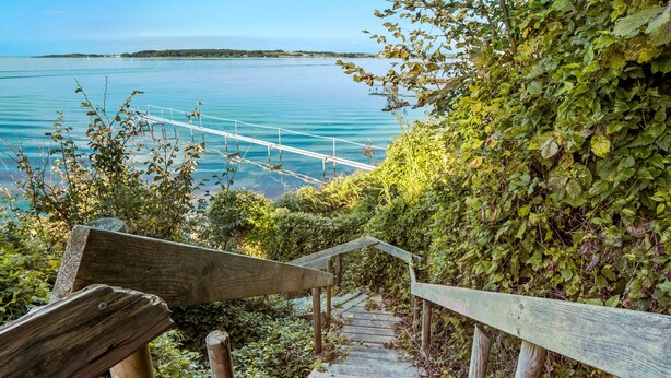 A wooden staircase leading to a bridge over a body of water.