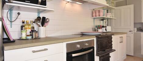 Fridge, stovetop, dishwasher, coffee/tea maker