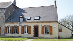 A two-story building with a sloped roof, dormer windows, and a brick facade. - 3 bedroom stunning home in Chigny (Chigny)