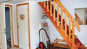 A staircase with wooden railings leading to an upper floor, a door with a heart-shaped decoration, and a vacuum cleaner in the hallway. - Gorgeous home in Ruda with kitchen (Ruda)
