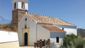 A white church with a bell tower and a tiled roof. - Amazing home in Corumbela (Corumbela)
