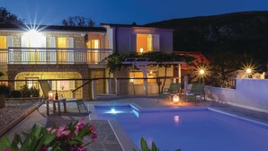 A two-story building with a swimming pool, outdoor seating, and a pergola. - Amazing home in Blato na Cetini (Blato na Cetini)