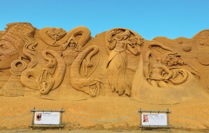 A detailed sand sculpture with various figures and symbols, including a snake and a woman. - 2 bedroom lovely home in Ringkøbing (Ringkøbing)