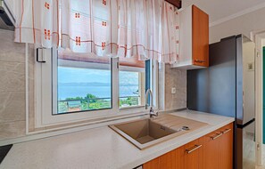 Fridge, stovetop, dishwasher, coffee/tea maker