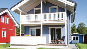 A two-story house with a balcony, a front porch, and a small shed. - Stunning home in Süssau/Ostsee (Süssau/Ostsee)