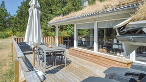 A deck with outdoor furniture, a pergola, and a view of the surrounding landscape. - Cozy home in Saltum with sauna (Saltum)