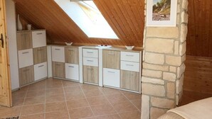 A compact kitchen with a skylight, stone wall, and tiled floor. - Apartment - Rügen-Fewo 291 (Sassnitz)
