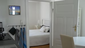 Ein Hotelzimmer mit Bett, Schreibtisch, Stuhl, einer Kaffeemaschine und Blick nach außen.
