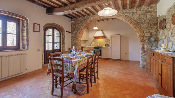 A rustic kitchen with stone walls, wooden beams, and a tiled floor. - Nice apartment in Montecatini V.C. (FI) (Montecatini V.C. (FI))