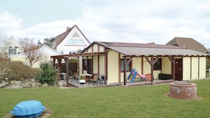 A two-story house with a covered patio area.