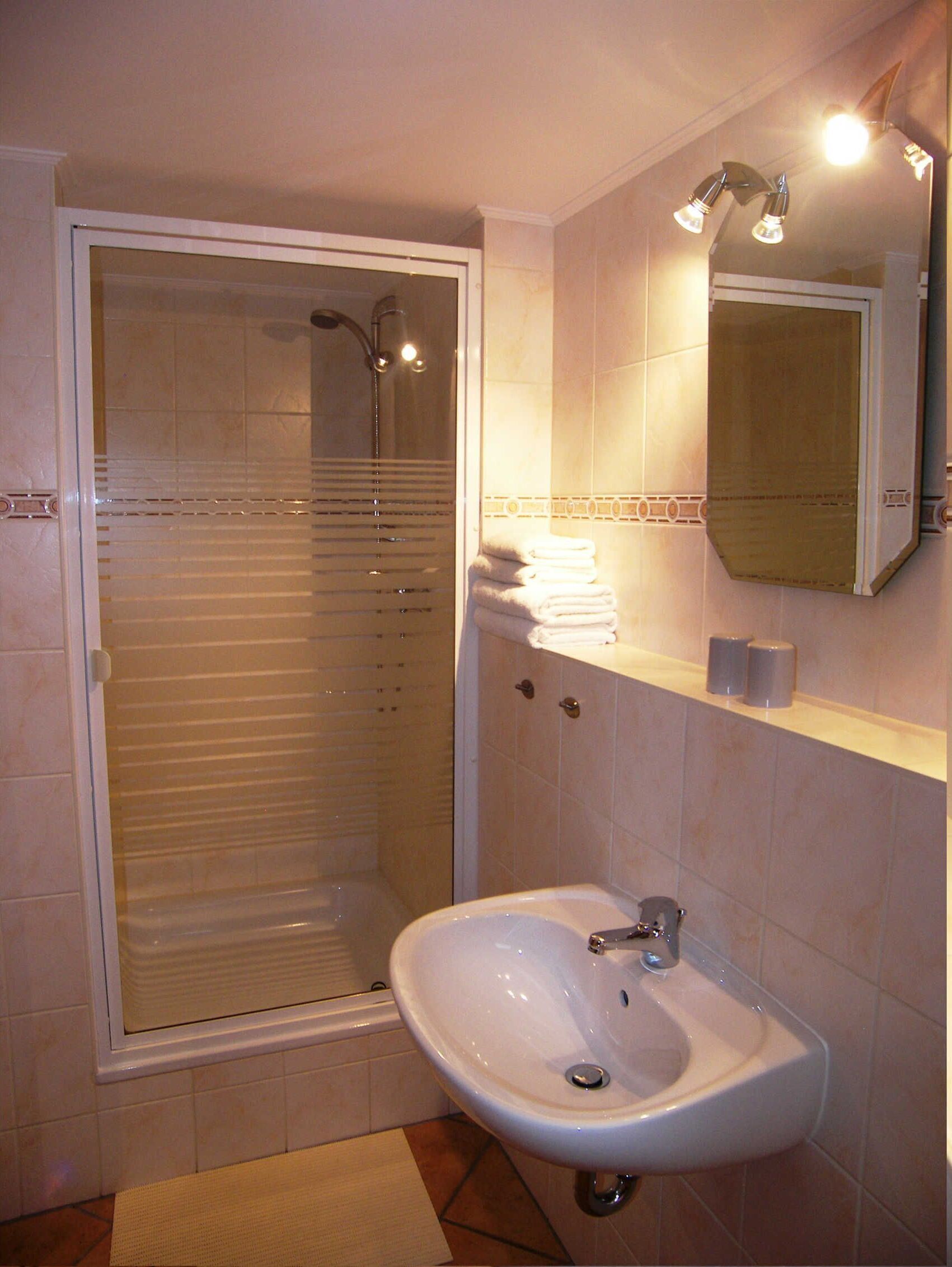 Shower, hair dryer, towels, toilet paper