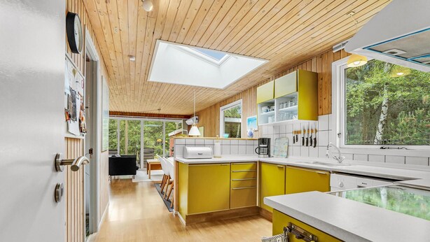 A modern kitchen with yellow cabinets, a wooden ceiling, and a skylight. - Pet friendly home in Hadsund with sauna (Hadsund)
