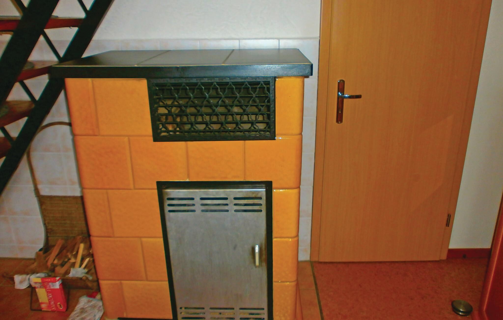 A compact kitchenette with a small refrigerator, a microwave, and a stove.